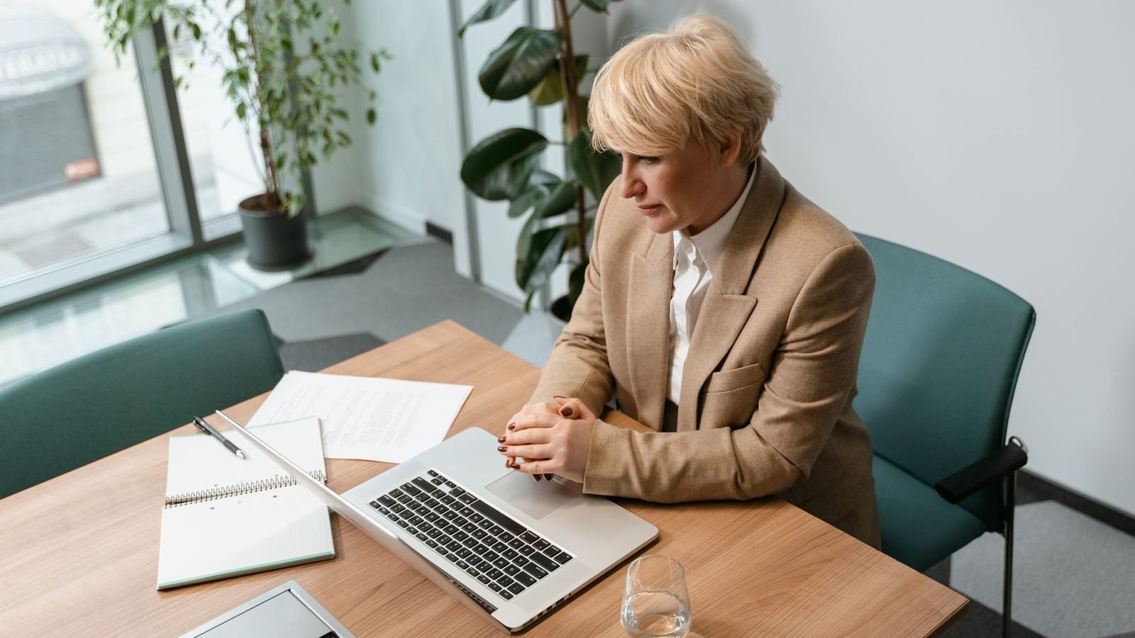 Office worker seated at a desk workstation, focus on posture during a display-screen equipment assessment