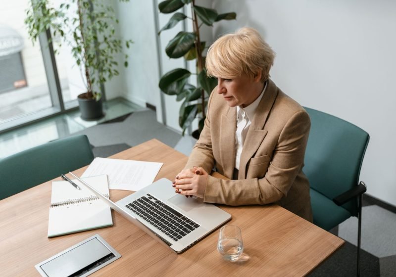 Office worker seated at a desk workstation, focus on posture during a display-screen equipment assessment