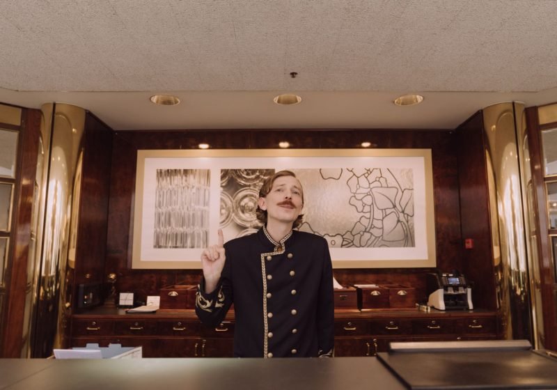 Friendly receptionist at a front desk ready to welcome visitors