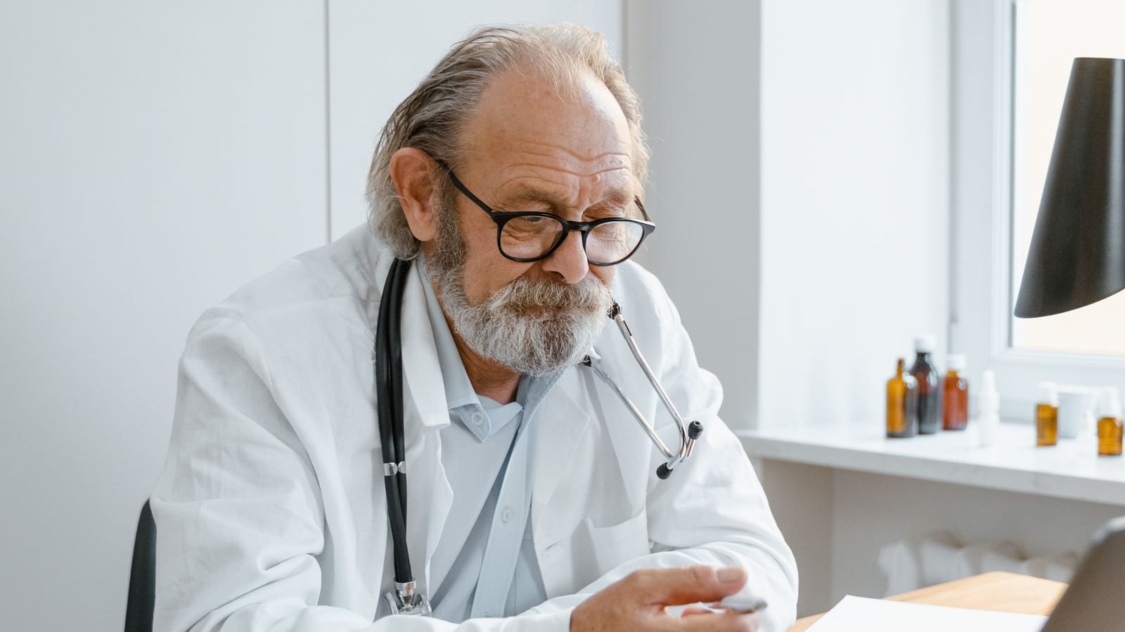 Clinician conducting a remote video consultation on a laptop from a clinic