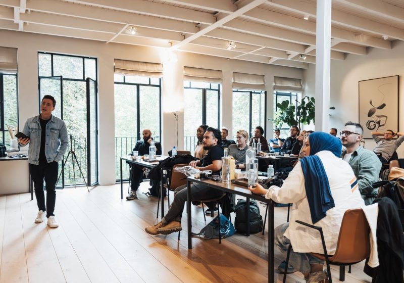 Facilitator leading a workplace training workshop for a small attentive group